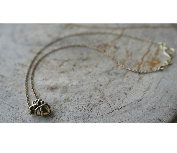 Necklace with a heart-shaped pendant on a textured surface